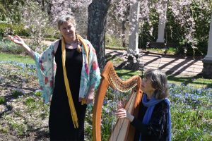 Diane in flowing outfit with Margot Chamberlain by her Celtic harp