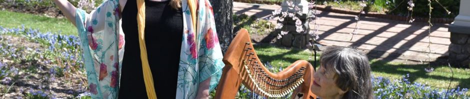 Diane in flowing outfit with Margot Chamberlain by her Celtic harp