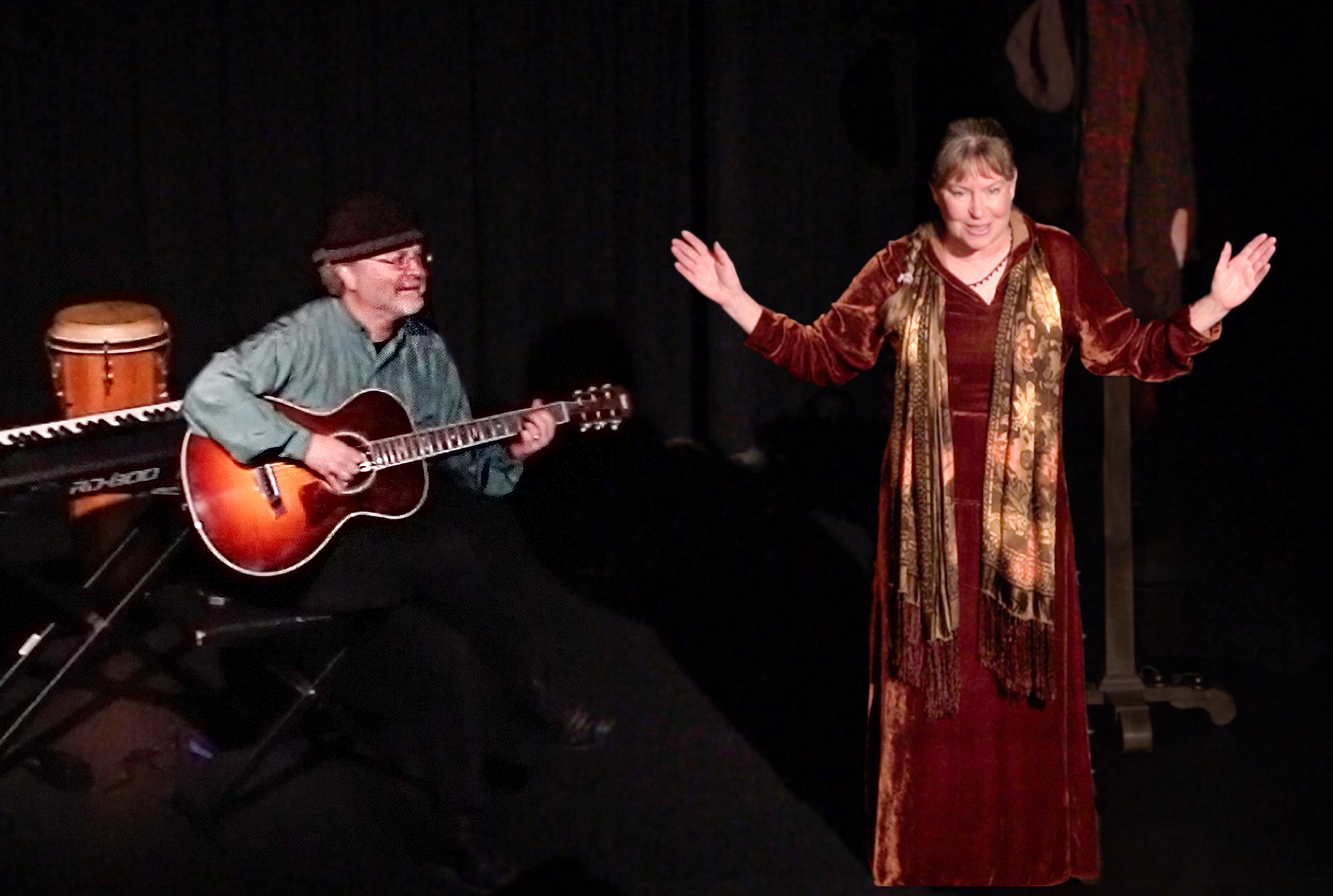 Diane in brown velvet arms spread wide. Theatre setting - Tom beside her accompanies the story on Guitar